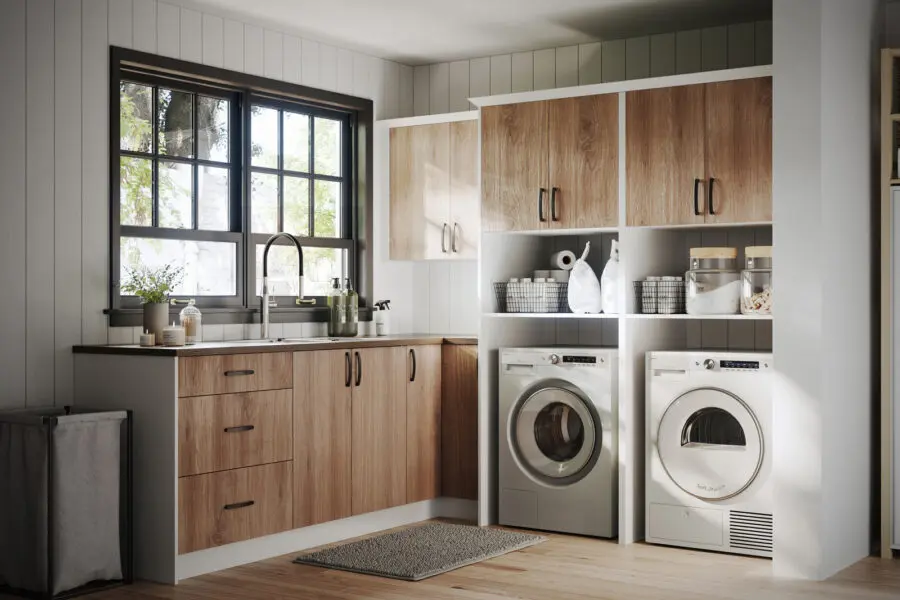Modern laundry room with warm wood cabinetry, black window frames, and a farmhouse-style sink.