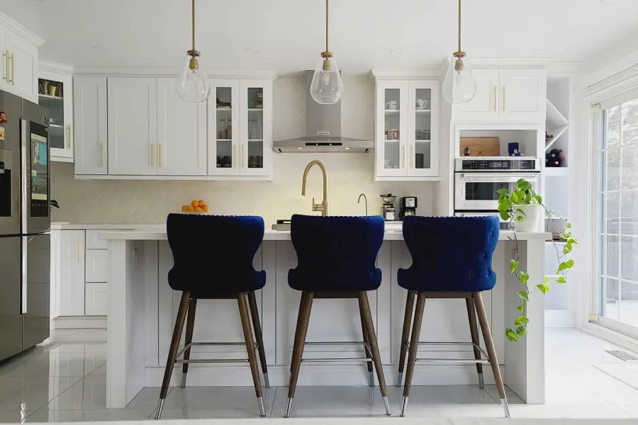 Kitchen island with vibrant fruits and vegetables, decorative accessories, and a stylish design.